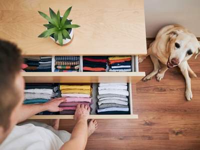 local house cleaning company folding clothes in bedroom