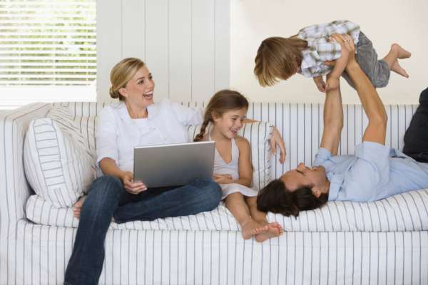 happy family on couch after apartment cleaning service is complete